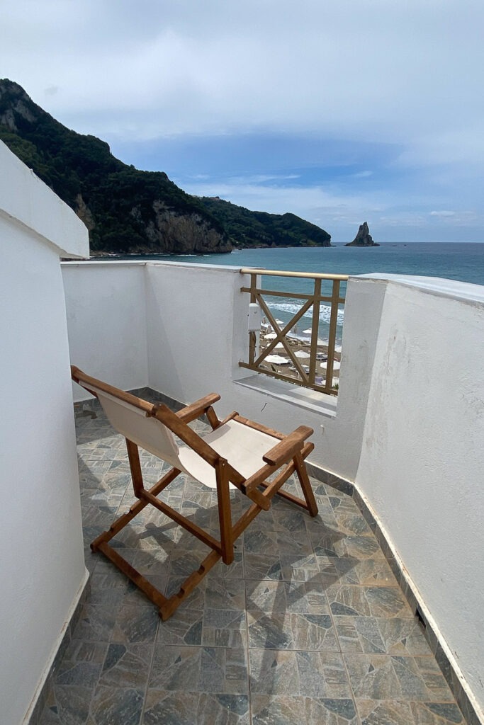 A chair on the balcony of Lysianassa with views of the beach.