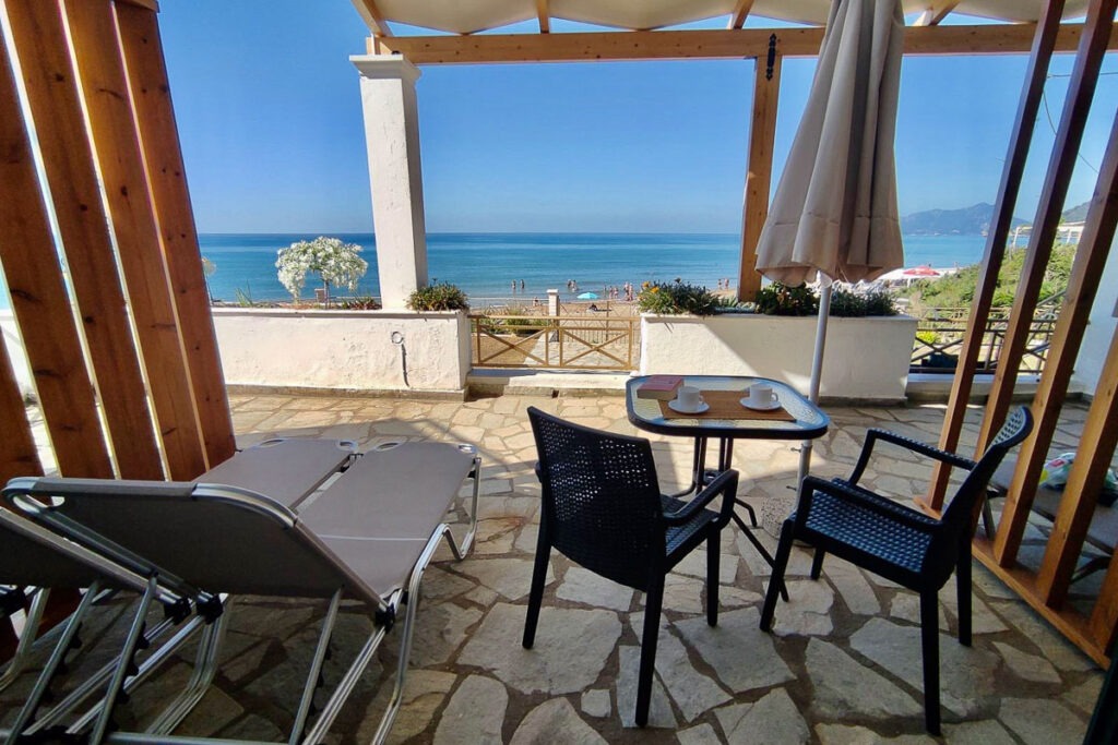 Two sunbeds and a table with two chairs in Melite terrace.