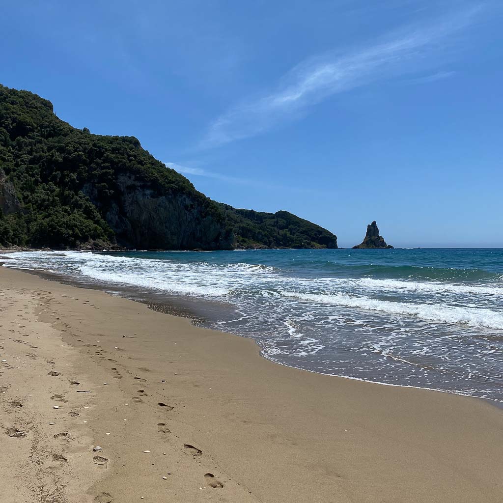 Our holiday apartments in Corfu are built on the sandy beach of Agios Gordios with its crystal clear waters and the iconic rock of Ortholithi in the background.