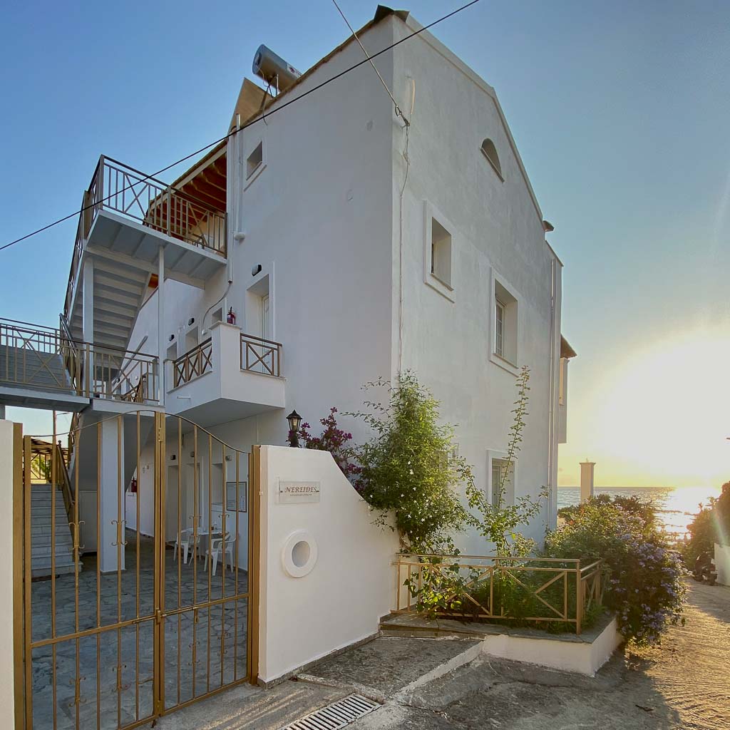 The entrance to Nereides Apartments Corfu. The building has two floor and an attic, as well as an external staircase to access the apartments.